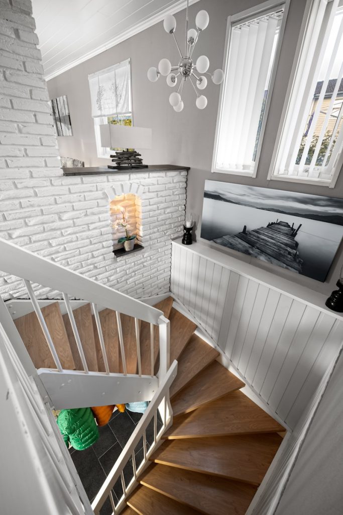A spiral staircase in a house with a picture on the wall