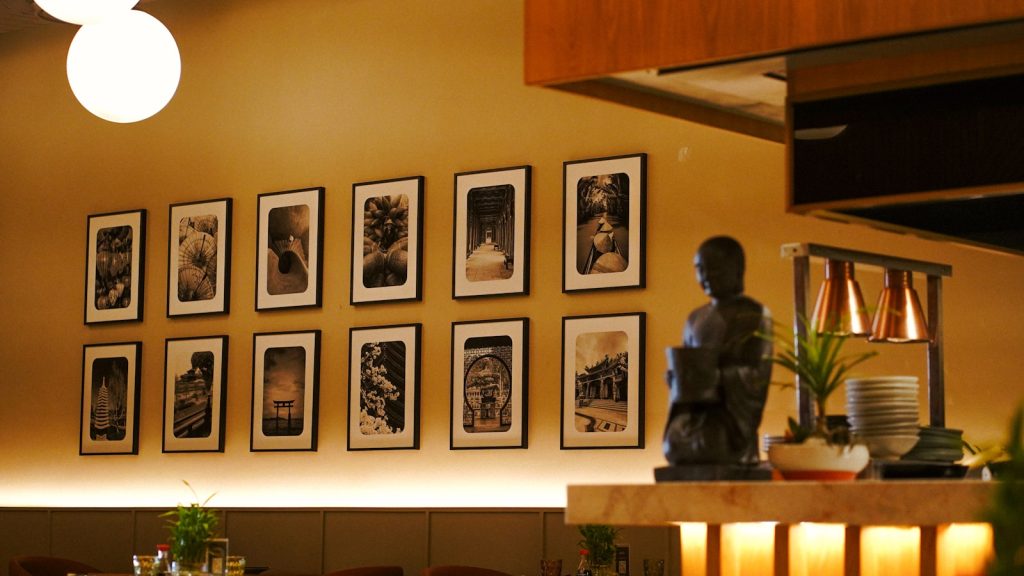 A dining room with pictures on the wall