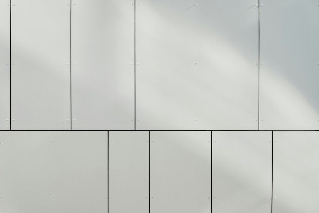 a white wall with a clock on the side of it